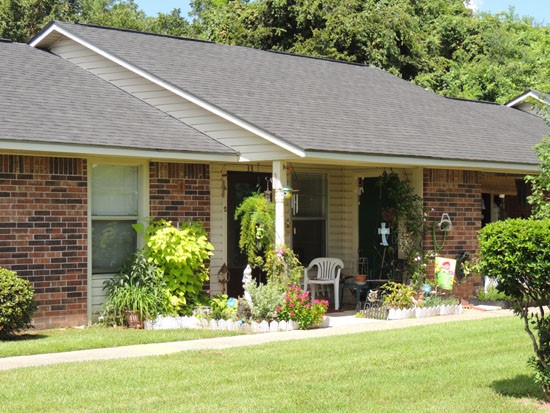 Heritage Village Closer look at front entrance into apartment with small sitting area outside
